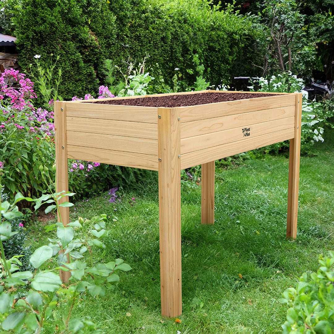 raised garden bed with legs on grass in the garden
