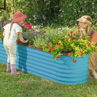 mother and child next to teal blue raised bed