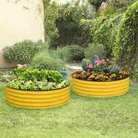 yellow galvanized raised garden bed on grass with plants