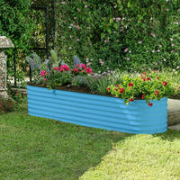 teal blue raised bed in the garden with plants and flowers