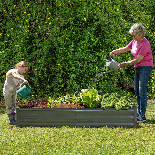 plant pots in the garden with mother and child watering the plants