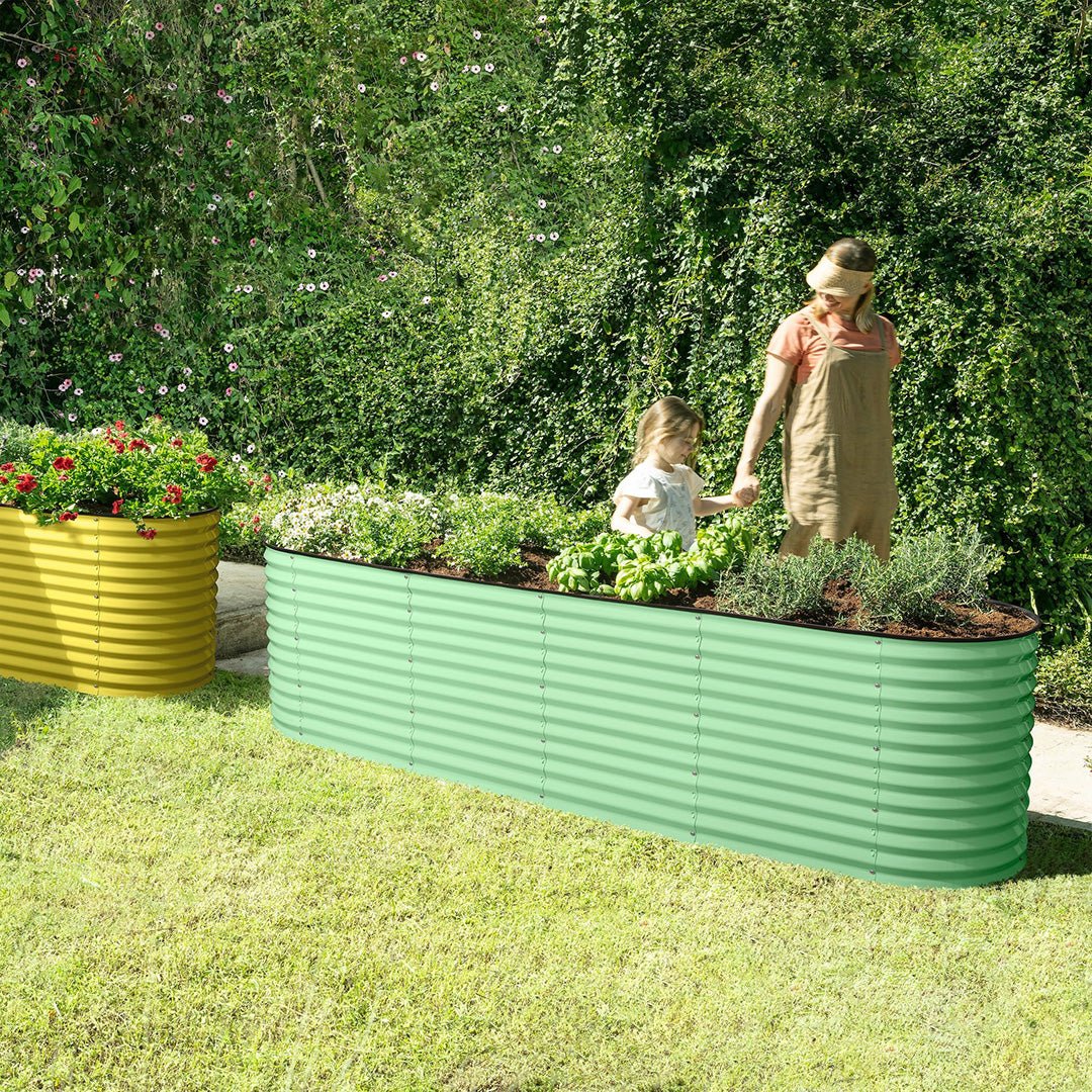 mother and chil in the garden next to green metal raised garden bed