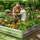 mother and child planting garden beds outdoor