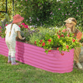 mother and child next to a raised garden bed