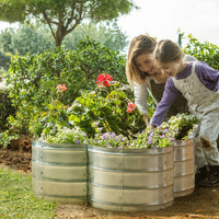 metal planter with mother and child planting