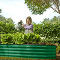 child planting with a planter boxes outdoor