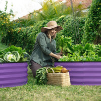 woman planting with a raised garden beds outdoor