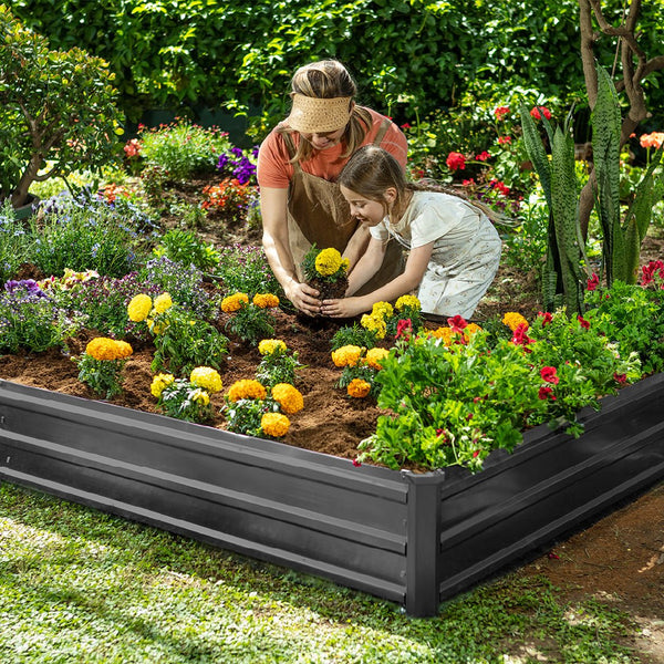 metal garden bed with mother and child planting