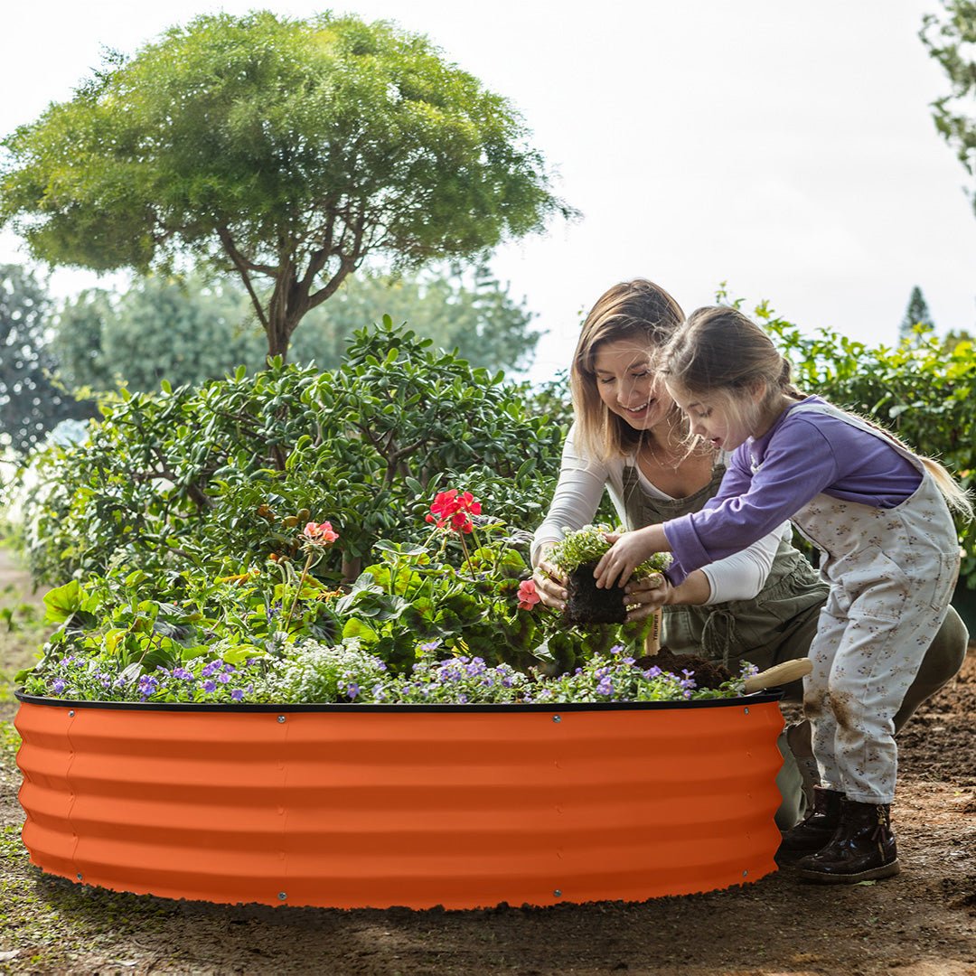 mother and daughter planting with a raised garden bed