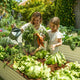 mother and daughter with raised beds for gardening vegetables